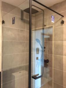 a shower with a glass door in a bathroom at Luxus Apartment über den Dächern vom Allgäu in Sonthofen