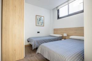 Posteľ alebo postele v izbe v ubytovaní Nervión Suites 1 - Vacacional Sevilla