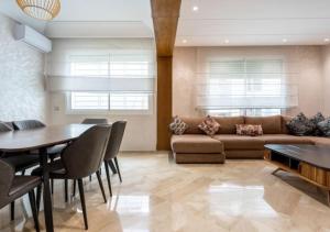 a living room with a couch and a table at Superbe appartement 2 chambres Maarif Val Fleuri in Casablanca