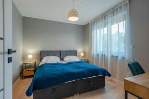 Posteľ alebo postele v izbe v ubytovaní Apartament Widok