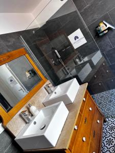 a bathroom with a white sink and a mirror at CASA LINDNER Villa Rustico Ferienhaus 400m zum Gardasee 13Schlafplätze in Toscolano Maderno