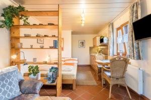 a living room with a couch and a dining room at Haus Rosi und Werner in Emmerting