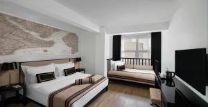 A bed or beds in a room at AKKA Lush Hotel Taksim
