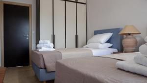 a hotel room with two beds with towels on them at Casa Avgerinou in Afantou