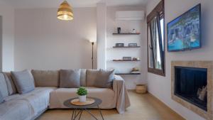 a living room with a couch and a fireplace at Casa Avgerinou in Afantou