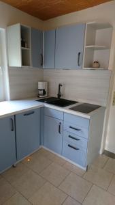 a kitchen with white cabinets and a sink at Ferienhaus auf Usedom, Neeberg in Krummin