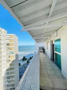 a balcony with a view of the ocean at AO SOM DO MAR - 15 metros da praia in Guarujá