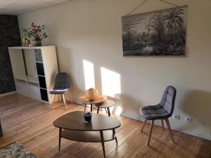 a living room with two chairs and a table at Gîte Loue in Ornans