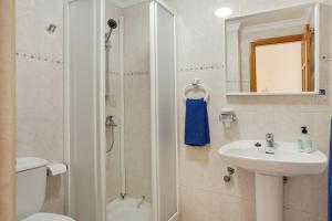 a bathroom with a toilet sink and a shower at Casa Luis Montesdeoca in Puerto de Mogán +19 photos