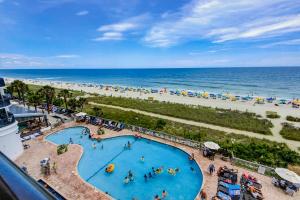 an overhead view of a swimming pool next to a beach at Caribbean Resort 525 in Myrtle Beach