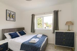a bedroom with a bed and a window at Alderton House - Spacious 3 Bed with Parking in Nottingham