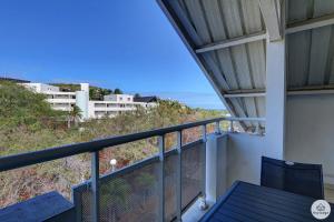 a balcony with a table and a view of the ocean at Amarena - 37m2 - Boucan Canot in Saint-Gilles les Bains