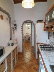 a kitchen with an archway leading to a dining room at Testaccio alloggio turistico in Rome
