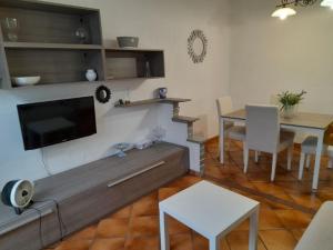 a living room with a flat screen tv and a table at Testaccio alloggio turistico in Rome