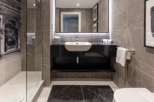 a bathroom with a sink and a shower and a toilet at Oulton Hall Hotel, Spa & Golf Resort in Leeds