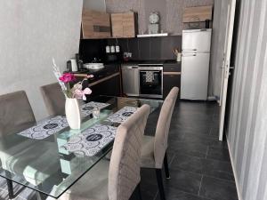 a kitchen with a glass table with chairs and a refrigerator at Schöne 3 Zimmer Wohnung in Oberwesel