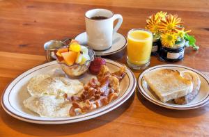 a table with two plates of breakfast food and a cup of coffee at Big Horn Lodge in Moab