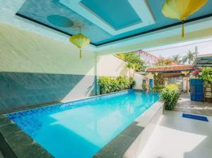a swimming pool in the middle of a house at Botanic Garden Villas in Hoi An