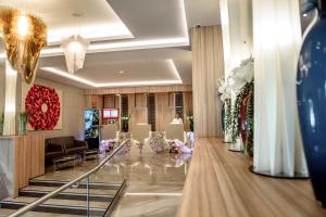 a lobby of a hotel with flowers on the floor at Ramada by Wyndham Ramnicu Valcea in Râmnicu Vâlcea