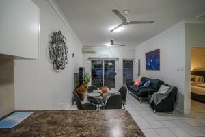 a living room with a couch and a table at ZEN HIDEAWAY COZY 2-BR/2-BA Modern Unit in Alawa in Casuarina