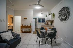 a living room and kitchen with a table and chairs at ZEN HIDEAWAY COZY 2-BR/2-BA Modern Unit in Alawa in Casuarina