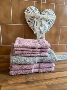 a pile of towels sitting on a counter next to a heart at UBYTOVÁNÍ ALENA in Ostrava