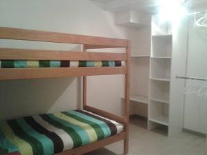 a small bedroom with bunk beds and a closet at Gîte de la P'tite Rainette in Grosne