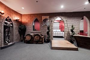 a room with a brick wall with chairs and tables at Chateau Avalon in Kansas City