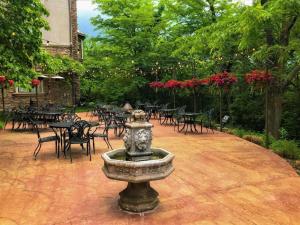 a fountain in the middle of a patio with tables and chairs at Chateau Avalon in Kansas City