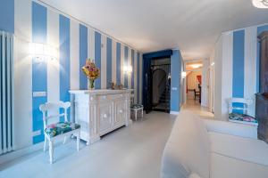 a blue and white room with two chairs and a dresser at Casa Azzurra in Messina