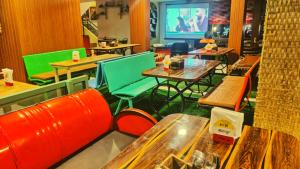 a restaurant with tables and chairs in a room at Rajdhani Resort Lonavala in Lonavala
