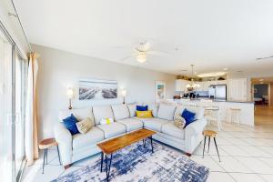 a living room with a white couch and a table at Amalfi Coast Resort A305 in Destin
