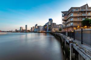 a view of a river in a city with buildings at Flourish Apartment - Constant Court - Canary Wharf in London