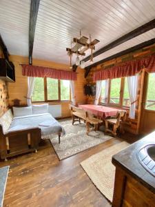 a bedroom with a bed and a table in a room at Nad Prutom Apartment in Tatariv