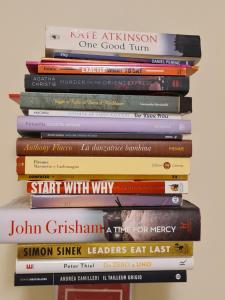 a pile of books stacked on top of each other at CASA DEI NONNI - Tresca Vecchia Apartment - Bari in Bari