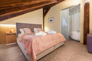 a bedroom with a large bed and a bath tub at Bern Boutique Hotel in Tallinn