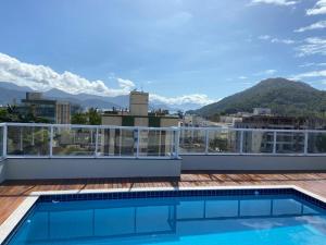 a swimming pool on the roof of a building at Ubatuba in Ubatuba