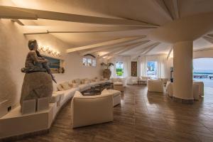 a living room with a statue of a woman sitting on a couch at Le Calette Bay in Cefalù