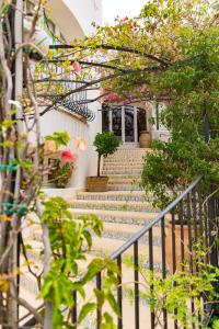 a set of stairs in a house with flowers at Le Calette Bay in Cefalù