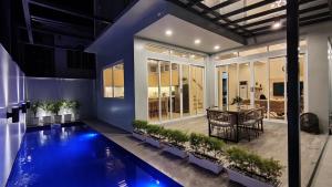 a house with a swimming pool and a dining room at Addie's Place Camella Homes 2D Muntinlupa in Manila