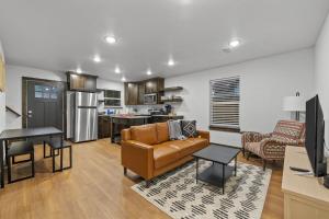 a living room with a couch and a kitchen at The Duo A2 miles to Magnolia in Waco