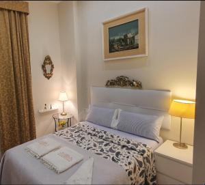 a bedroom with a bed with two towels on it at Cozy LUXURY apartments*****. The city center in Valencia