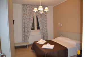 a bedroom with a bed with two towels on it at Villa del Principe in Carini +27 photos