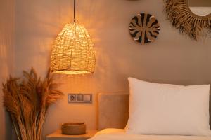 a bedroom with a bed and a pendant light at Soas Suites in Alacati +52 photos
