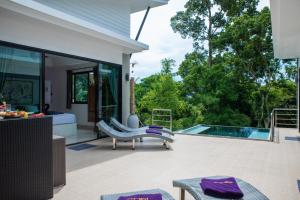 a patio with a swimming pool and a house at Villa Anne in Lamai
