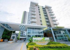 a large building with a sign in front of it at Mesatierra Garden Residences in Davao City