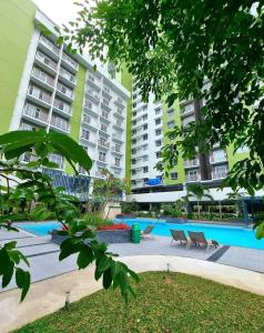 a courtyard of a building with chairs and buildings at Mesatierra Garden Residences in Davao City
