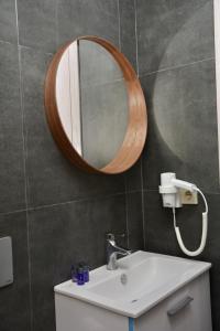 a bathroom with a sink and a mirror on the wall at My Sun Hotel in İzmir