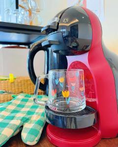 a red mixer sitting on a table with a glass at One season poolvilla in Bang Sare