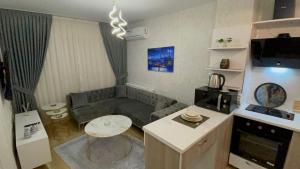 a small living room with a couch and a table at Classic Suite BH13 in Esenyurt